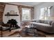 Bright living room features exposed brick fireplace, large windows, and hardwood floors, creating a cozy atmosphere at 2085 Krameria St, Denver, CO 80207