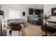 Open-concept living room with modern furnishings, hardwood floors, and a stylish kitchen in the background at 2085 Krameria St, Denver, CO 80207