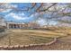 Expansive backyard featuring lush lawn, mature trees, brick patio, and privacy fence at 3700 Miller St, Wheat Ridge, CO 80033