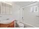 Clean bathroom with tiled shower and tub combination, modern vanity, and medicine cabinet at 3700 Miller St, Wheat Ridge, CO 80033