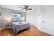 Bedroom with wood floors, neutral paint, ceiling fan, and a window with natural light at 3700 Miller St, Wheat Ridge, CO 80033