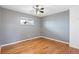 Cozy bedroom featuring hardwood floors, a ceiling fan, neutral paint, and a window at 3700 Miller St, Wheat Ridge, CO 80033