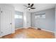 Well-lit bedroom with hardwood floors, modern fan, and multiple windows offering natural light at 3700 Miller St, Wheat Ridge, CO 80033