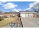 Charming home featuring a two-car garage, brick accents, and a welcoming front deck at 3700 Miller St, Wheat Ridge, CO 80033