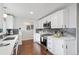 Contemporary kitchen with white cabinetry and stainless steel appliances at 3700 Miller St, Wheat Ridge, CO 80033