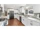 Bright kitchen featuring white cabinets, stainless appliances, backsplash, and quartz counters at 3700 Miller St, Wheat Ridge, CO 80033