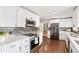 Modern kitchen with stainless steel appliances, white cabinets, and ample counter space at 3700 Miller St, Wheat Ridge, CO 80033