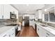 Modern kitchen features white cabinetry, stainless steel appliances, and sleek countertops at 3700 Miller St, Wheat Ridge, CO 80033