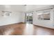 Spacious living room featuring wood floors, natural light, and sliding glass door leading to a patio at 3700 Miller St, Wheat Ridge, CO 80033