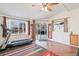 Bright living room with wood floor, large windows, sliding doors, and a treadmill at 3700 Miller St, Wheat Ridge, CO 80033