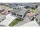 Aerial view of a home featuring a three-car garage, pergola, patio, fenced backyard, and landscaping at 5584 Turnbury Cir, Elizabeth, CO 80107