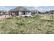 Backyard featuring a pergola, patio, fire pit with stone border, and sprawling grassy area for outdoor activities at 5584 Turnbury Cir, Elizabeth, CO 80107