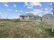 Spacious backyard featuring green grass, a stone fire pit, shed and well-maintained landscaping at 5584 Turnbury Cir, Elizabeth, CO 80107