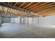 Large unfinished basement with exposed ceiling, showing ample space for future customization at 5584 Turnbury Cir, Elizabeth, CO 80107