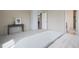 Bedroom with carpeted floors, a console table, and a door that opens into a dining room and bathroom at 5584 Turnbury Cir, Elizabeth, CO 80107