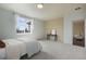This bedroom features carpeted floors, a console table, and a large window with white curtains at 5584 Turnbury Cir, Elizabeth, CO 80107