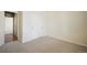 This bedroom features carpeted floors, bare walls, a closet with sliding doors, and an open door at 5584 Turnbury Cir, Elizabeth, CO 80107