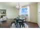 Dining area with views from the window, chandelier, hardwood floors and place settings for a dinner at 5584 Turnbury Cir, Elizabeth, CO 80107
