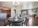 Open-concept dining room leading into the living area, showcasing a modern chandelier and stylish decor at 5584 Turnbury Cir, Elizabeth, CO 80107