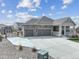 Charming home featuring a large driveway, three-car garage, and covered front porch at 5584 Turnbury Cir, Elizabeth, CO 80107