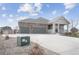Charming single-Gathering home featuring a stone and siding exterior, two-car garage, and covered front porch at 5584 Turnbury Cir, Elizabeth, CO 80107
