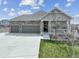 Inviting single-Gathering home with a three-car garage, stone accents, and a covered porch at 5584 Turnbury Cir, Elizabeth, CO 80107