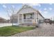 Craftsman-style home featuring stone accents, a cozy front porch with white railings, and well-maintained landscaping at 5584 Turnbury Cir, Elizabeth, CO 80107