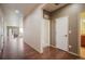 Hallway with hardwood floors, neutral paint, and direct access to other rooms at 5584 Turnbury Cir, Elizabeth, CO 80107