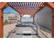 Backyard hot tub with a wooden pergola providing shade and ambiance for relaxation and entertainment at 5584 Turnbury Cir, Elizabeth, CO 80107