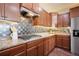 The kitchen offers stainless steel appliances, granite countertops, a gas cooktop, and ample cabinet space at 5584 Turnbury Cir, Elizabeth, CO 80107