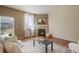 Comfortable living room with fireplace, plush seating, and natural light from the window at 5584 Turnbury Cir, Elizabeth, CO 80107