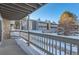 Balcony view of complex featuring snow, gray siding, and stone accents on a sunny winter day at 18105 E Ohio Ave # 102, Aurora, CO 80017