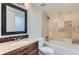 Bathroom featuring stylish mosaic backsplash, granite counters, tub, and tan-tiled shower surround at 18105 E Ohio Ave # 102, Aurora, CO 80017