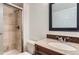 Bathroom featuring a shower, granite vanity, designer accent tiles and a large mirror at 18105 E Ohio Ave # 102, Aurora, CO 80017