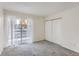 Well-lit bedroom with sliding glass door access to private balcony, plush carpeting and ample closet space at 18105 E Ohio Ave # 102, Aurora, CO 80017