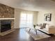 Comfortable living area featuring a stone fireplace, and sliding door to the exterior at 18105 E Ohio Ave # 102, Aurora, CO 80017