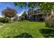 Expansive, well-manicured backyard with mature trees, perfect for outdoor activities and entertaining at 4247 Thistlesage Ct, Castle Rock, CO 80109