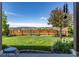 Private backyard with a lush lawn, wooden fence and mature trees offering scenic views at 4247 Thistlesage Ct, Castle Rock, CO 80109
