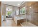 Bright bathroom showcasing a soaking tub, separate shower and neutral tile at 4247 Thistlesage Ct, Castle Rock, CO 80109