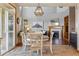 Cozy dining area featuring a stylish pendant light, backyard access, and views into the living room at 4247 Thistlesage Ct, Castle Rock, CO 80109