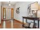 Home entryway featuring hardwood floors, console table, and decorative wall art at 4247 Thistlesage Ct, Castle Rock, CO 80109