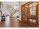 Spacious foyer featuring hardwood floors, staircase, and glass-paneled office doors at 4247 Thistlesage Ct, Castle Rock, CO 80109