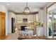 Updated kitchen featuring white cabinets, modern appliances, and pendant lighting above a dining area at 4247 Thistlesage Ct, Castle Rock, CO 80109