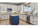 Bright kitchen with granite counters, stainless steel appliances, and island with breakfast bar at 4247 Thistlesage Ct, Castle Rock, CO 80109