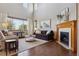 Bright living room with high ceilings, a fireplace, and large windows with natural light at 4247 Thistlesage Ct, Castle Rock, CO 80109