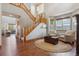 Open-concept living room with hardwood floors, staircase, and comfortable seating area at 4247 Thistlesage Ct, Castle Rock, CO 80109