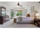 Bright main bedroom featuring plush carpet, tray ceilings and large windows that provide lots of light at 4247 Thistlesage Ct, Castle Rock, CO 80109