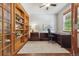 Bright home office with built-in bookshelves, desk, and natural light at 4247 Thistlesage Ct, Castle Rock, CO 80109