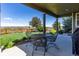 Covered patio with metal table and chairs offers views of the fenced yard and neighborhood at 4247 Thistlesage Ct, Castle Rock, CO 80109