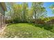 Expansive backyard with lush green grass and mature trees, perfect for outdoor activities at 8150 W Calhoun Dr, Littleton, CO 80123